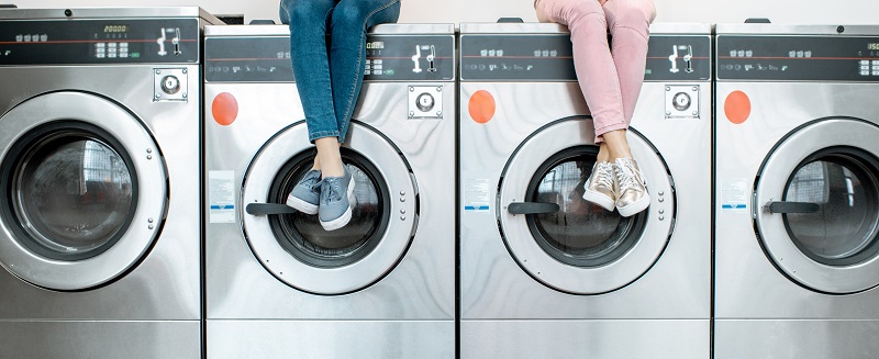 Women,Sitting,On,The,Washing,Machines,Waiting,For,The,Washing
